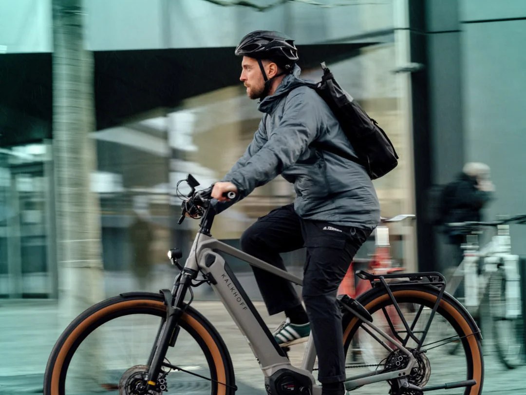 Commuter riding an e-bike through the city