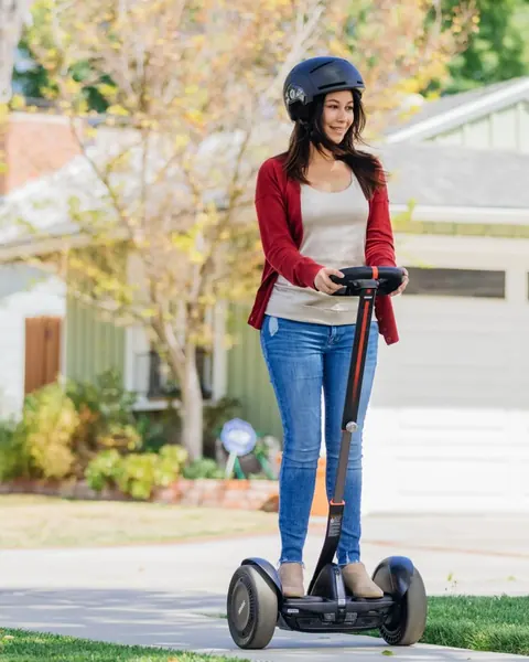 A rider in a helmet on the Segway S-Max self-balancer
